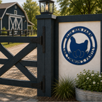 Blue personalized chicken farm metal sign displayed on outdoor farm gate with barn and flowers