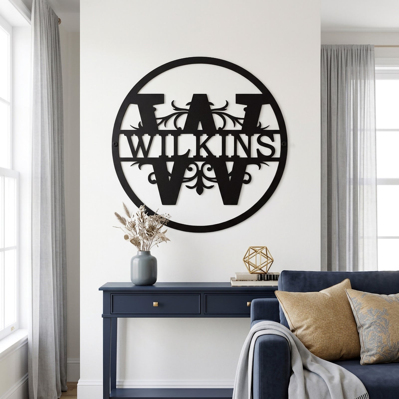 Personalized Wilkinson metal monogram wall decor displayed in a bright modern living room with navy furniture