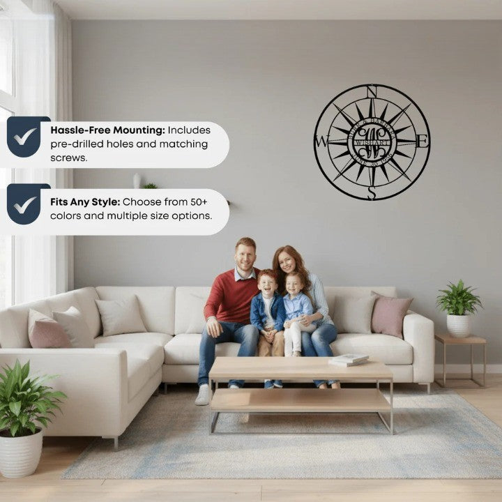 Black metal nautical compass rose sign with custom family name mounted in a modern living room above a family on a sofa.