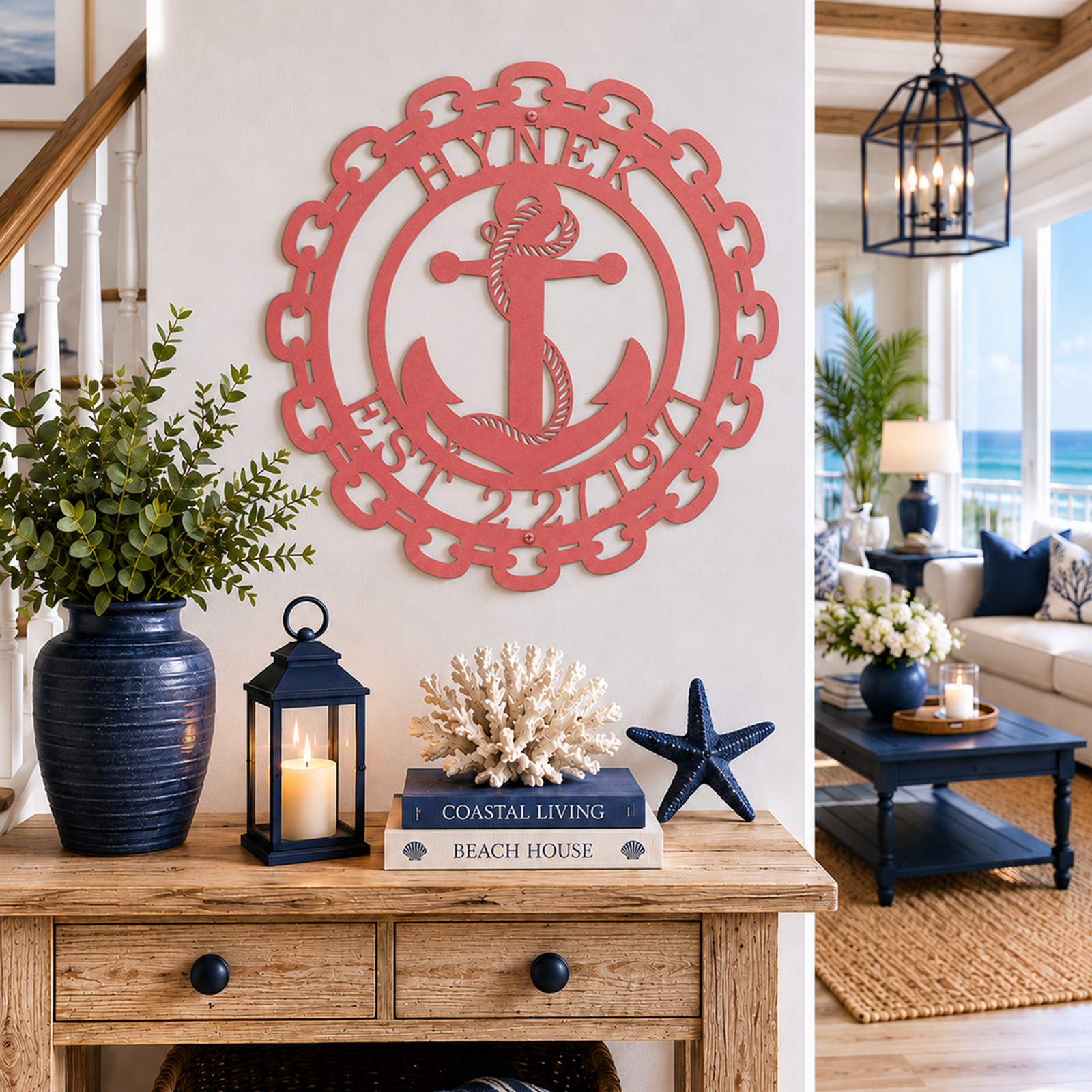 Coral pink variation of the personalized family name anchor metal sign styled on a white entryway wall above a console table with beach house decor.