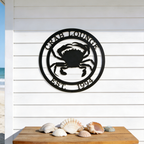Black crab lounge metal sign with crab design displayed above seashell table decor