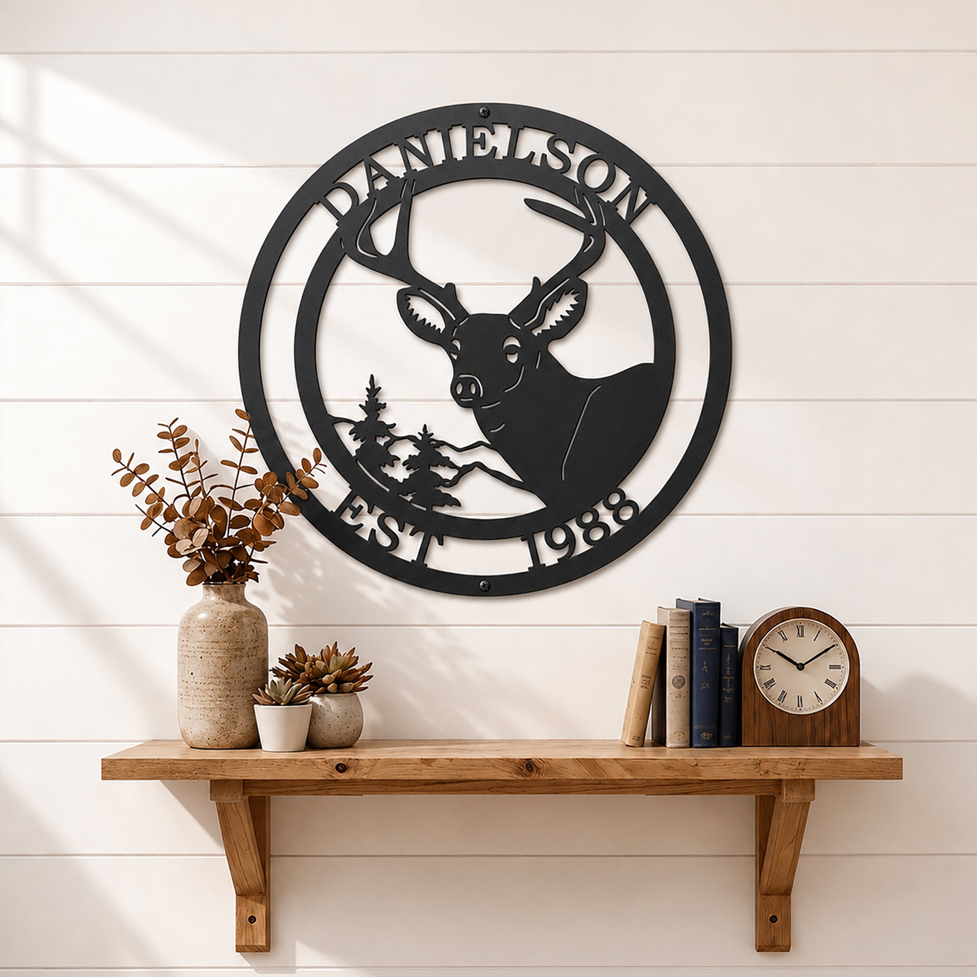 Black deer metal wall sign with personalized surname and EST 1988 displayed on white shiplap wall shelf décor