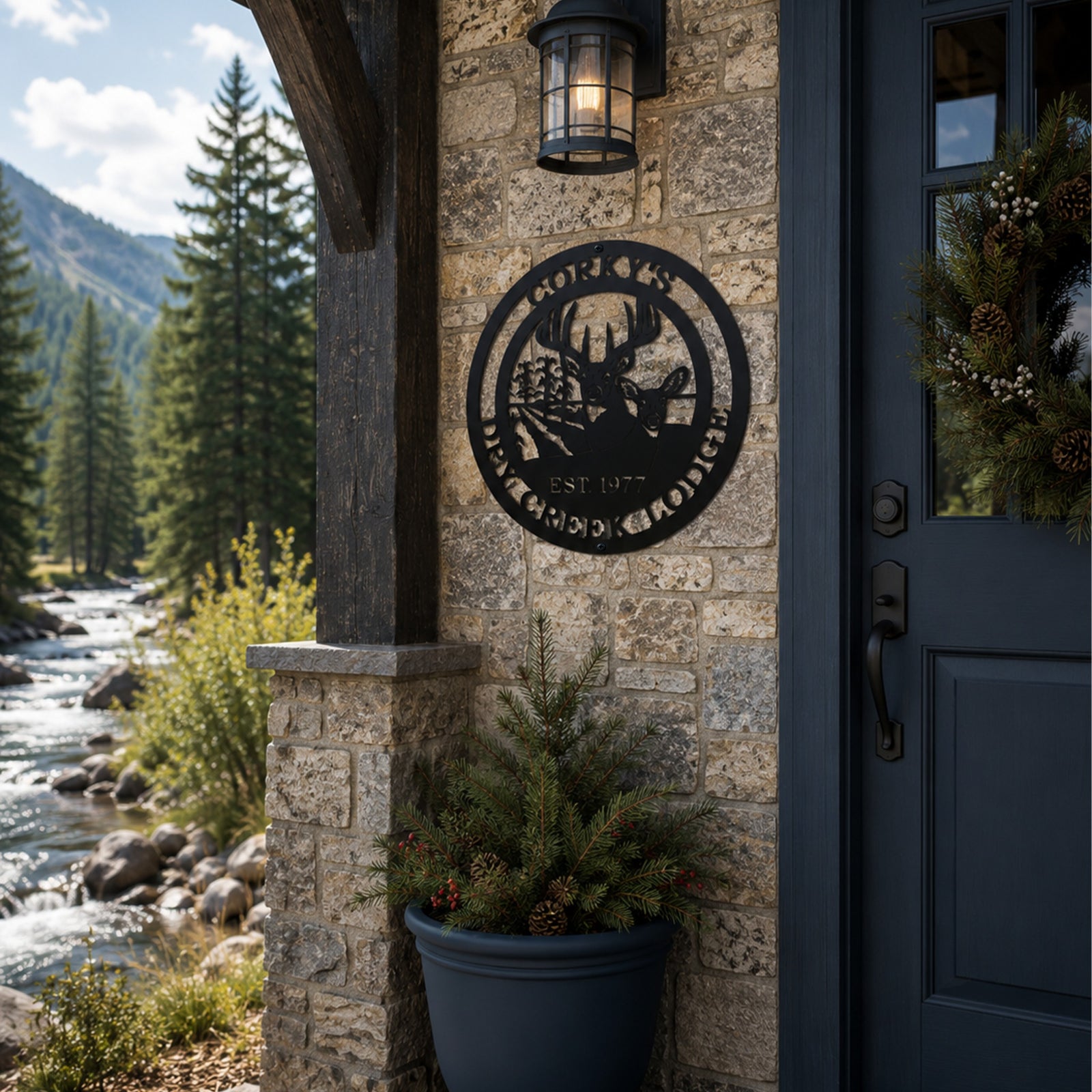 Black personalized deer lodge metal sign with buck doe corn field and established date displayed beside a stone entryway