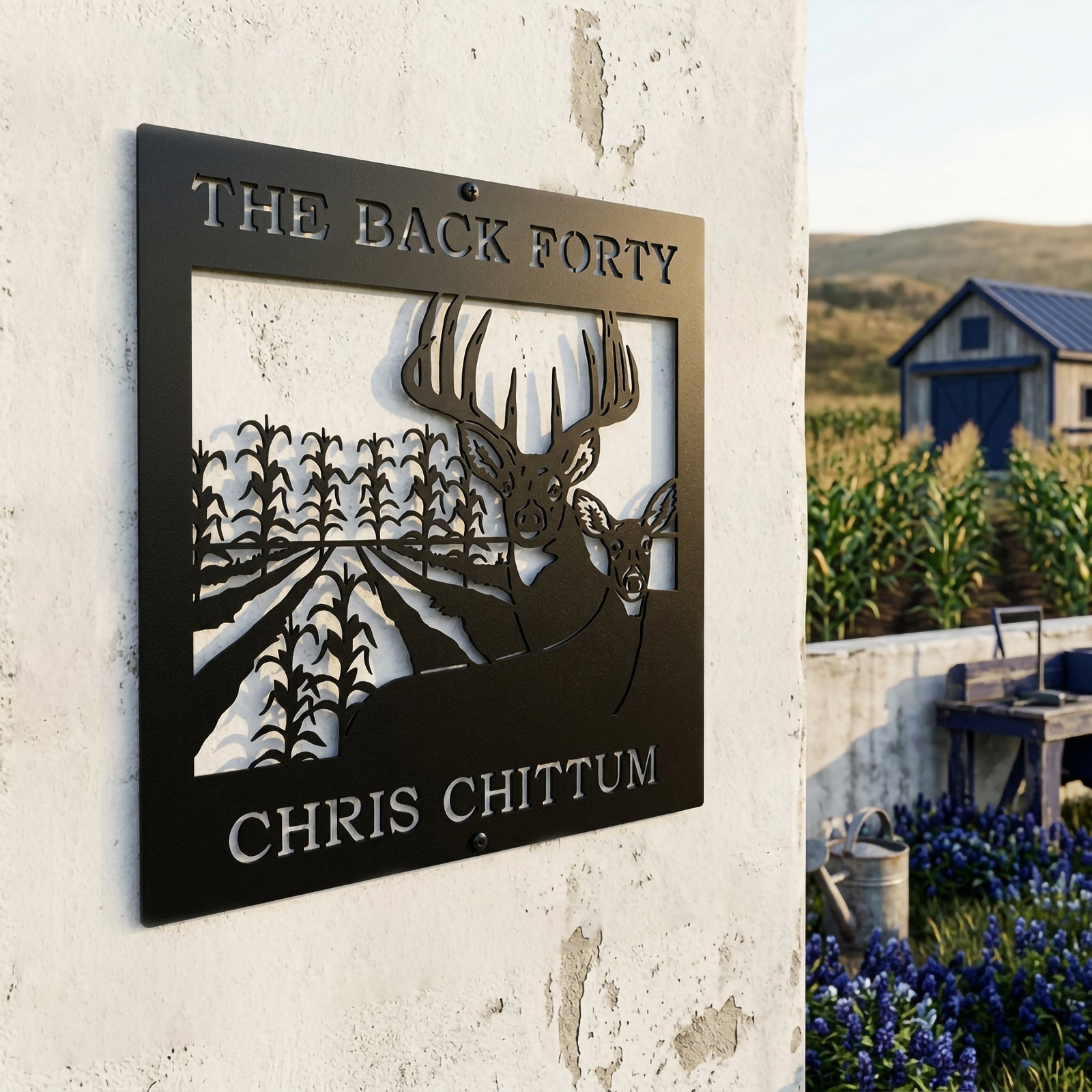 Satin black custom deer and cornfield metal sign displayed on farmhouse exterior with garden and blue barn