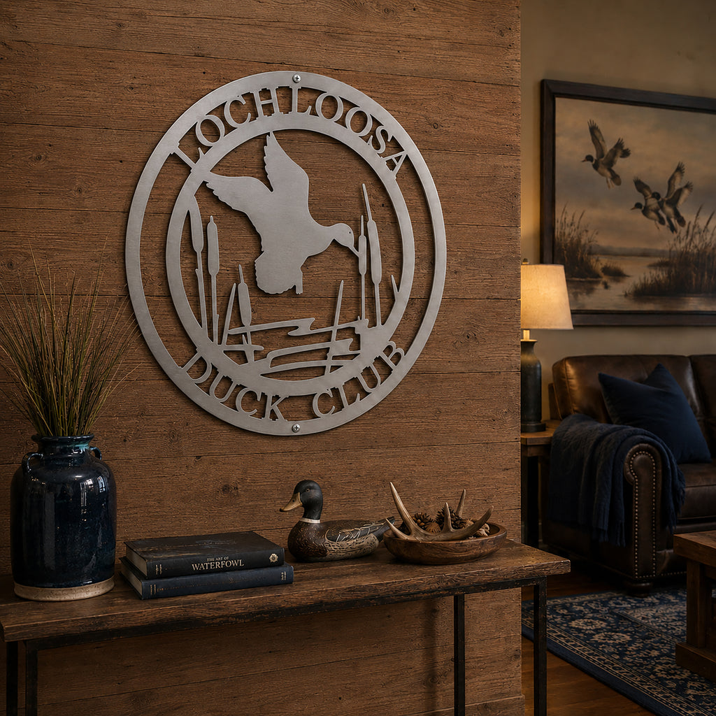 Raw metal duck club wall decor with flying duck and cattails on rustic wood entry wall