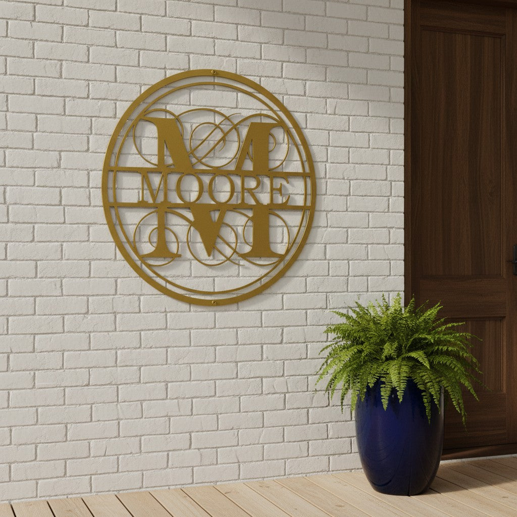Custom family monogram metal sign — personalized gold last name wall decor mounted on a white brick wall near a front entryway.
