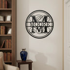 Custom family monogram metal sign — personalized surname wall art featuring an elegant circular monogram displayed in a home library and living space.