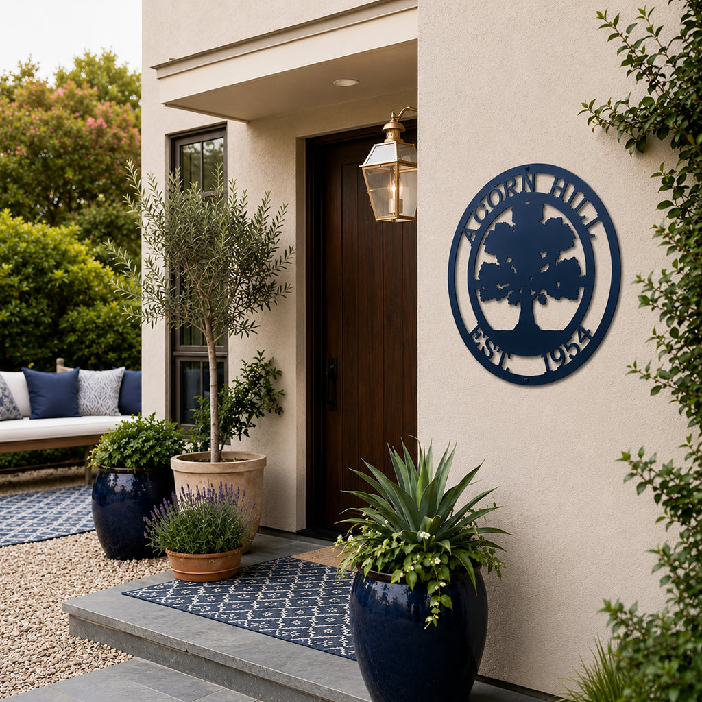 Navy blue oak tree family name metal sign displayed beside modern front door