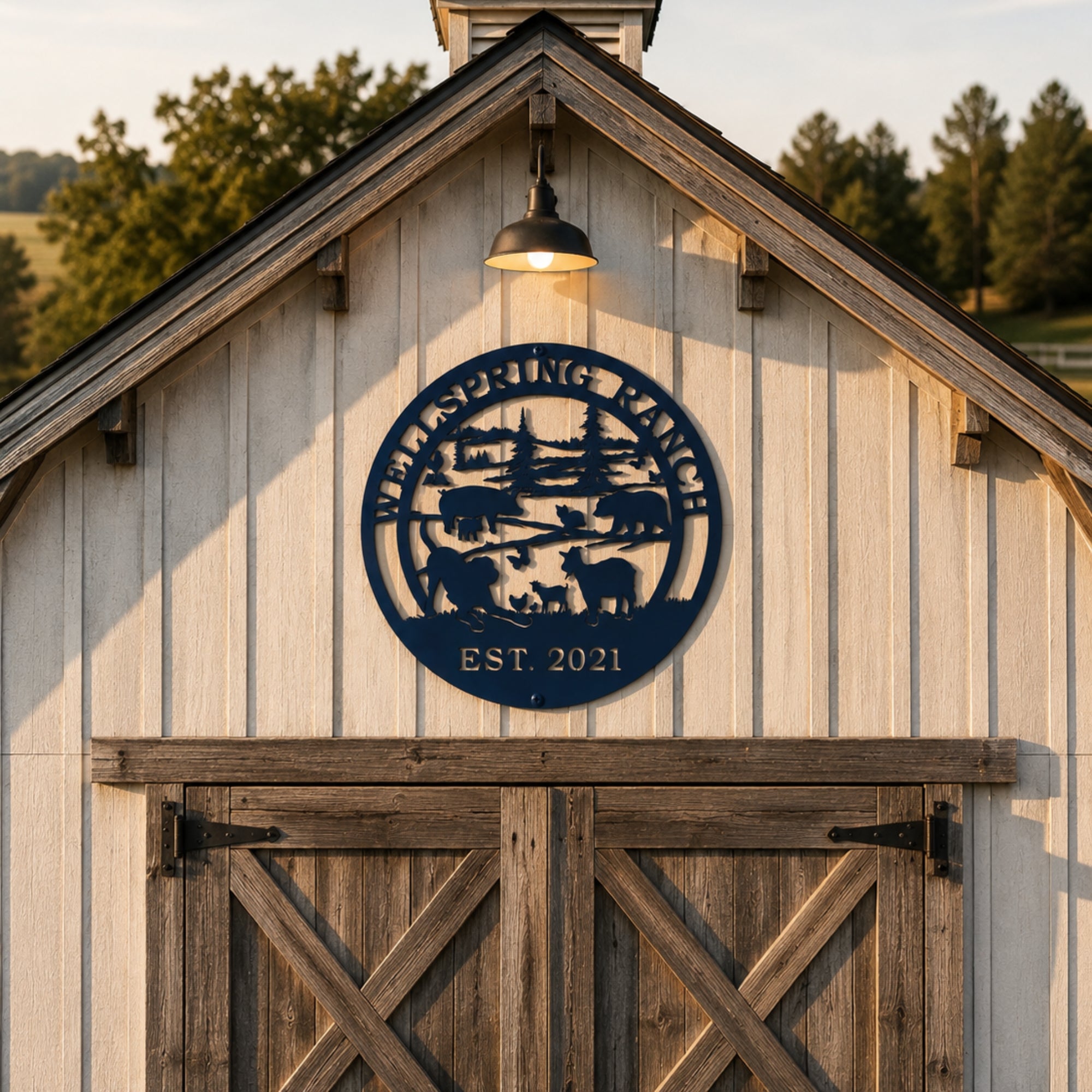 Round navy blue ranch metal wall art mounted above rustic barn doors with personalized ranch name and established year