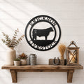 Black livestock metal wall sign with cattle silhouette and custom farm name displayed above rustic farmhouse shelf décor