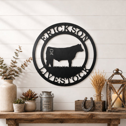 Black livestock metal wall sign with cattle silhouette and custom farm name displayed above rustic farmhouse shelf décor