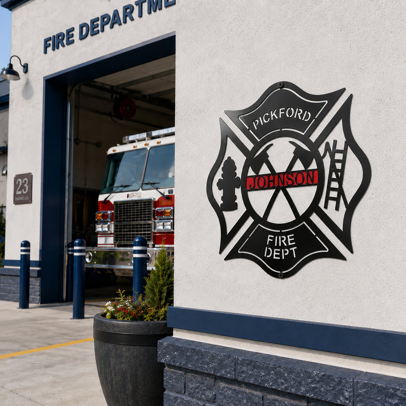 Black firefighter metal wall decor with custom Pickford Johnson design mounted outside modern fire department station