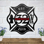 Black metal Maltese cross sign with a fire hydrant and ladder, featuring a custom Station 32 red nameplate.