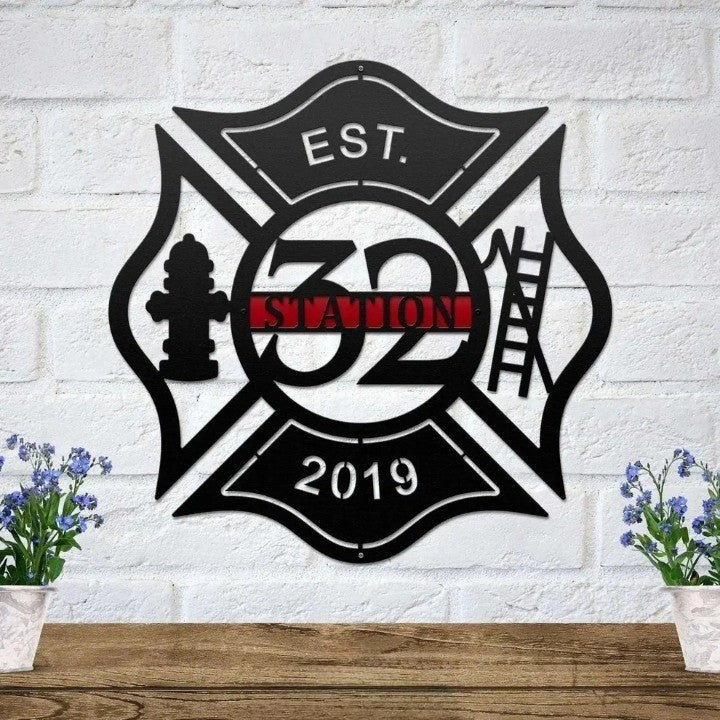 Black metal Maltese cross sign with a fire hydrant and ladder, featuring a custom Station 32 red nameplate.