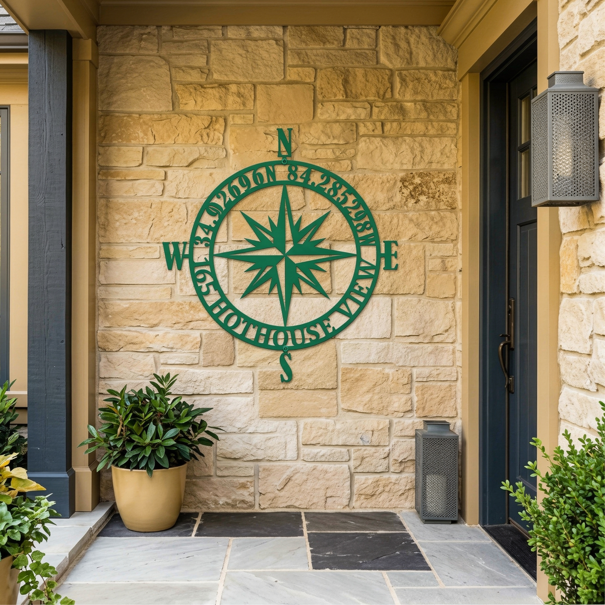 Custom Front Porch Address Compass Metal Sign in a green finish, styled on a rustic stone entryway wall.