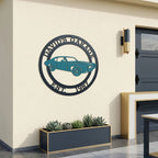 Personalized garage metal wall sign featuring classic muscle car design with custom garage name and established date mounted on modern outdoor garage wall