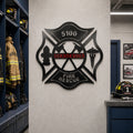 Custom Henderson Fire Rescue Maltese Cross metal wall sign displayed in firefighter locker room with helmets and turnout gear