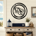 Black lobster metal wall sign with The Lloyds and Est 2022 displayed above coastal console table and nautical decor