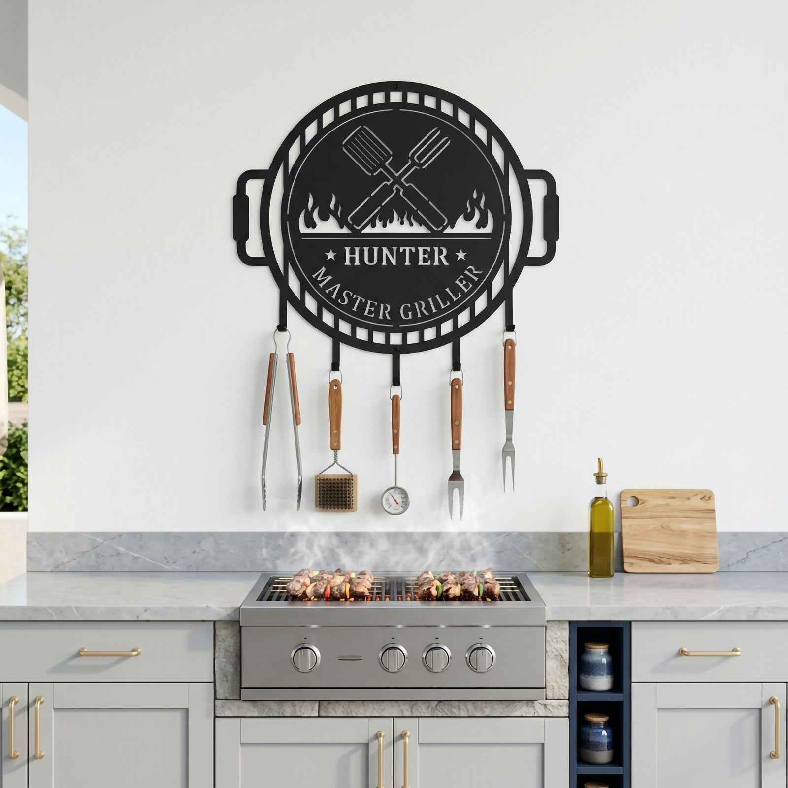 Custom master griller metal BBQ wall sign with hanging grill tools displayed above outdoor cooking station and barbecue grill