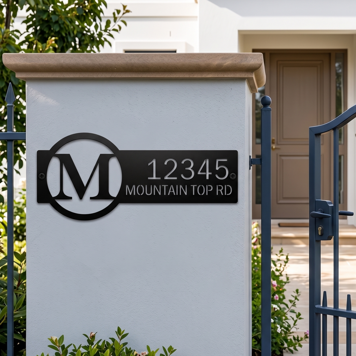 Black custom house number metal sign displayed on front gate pillar
