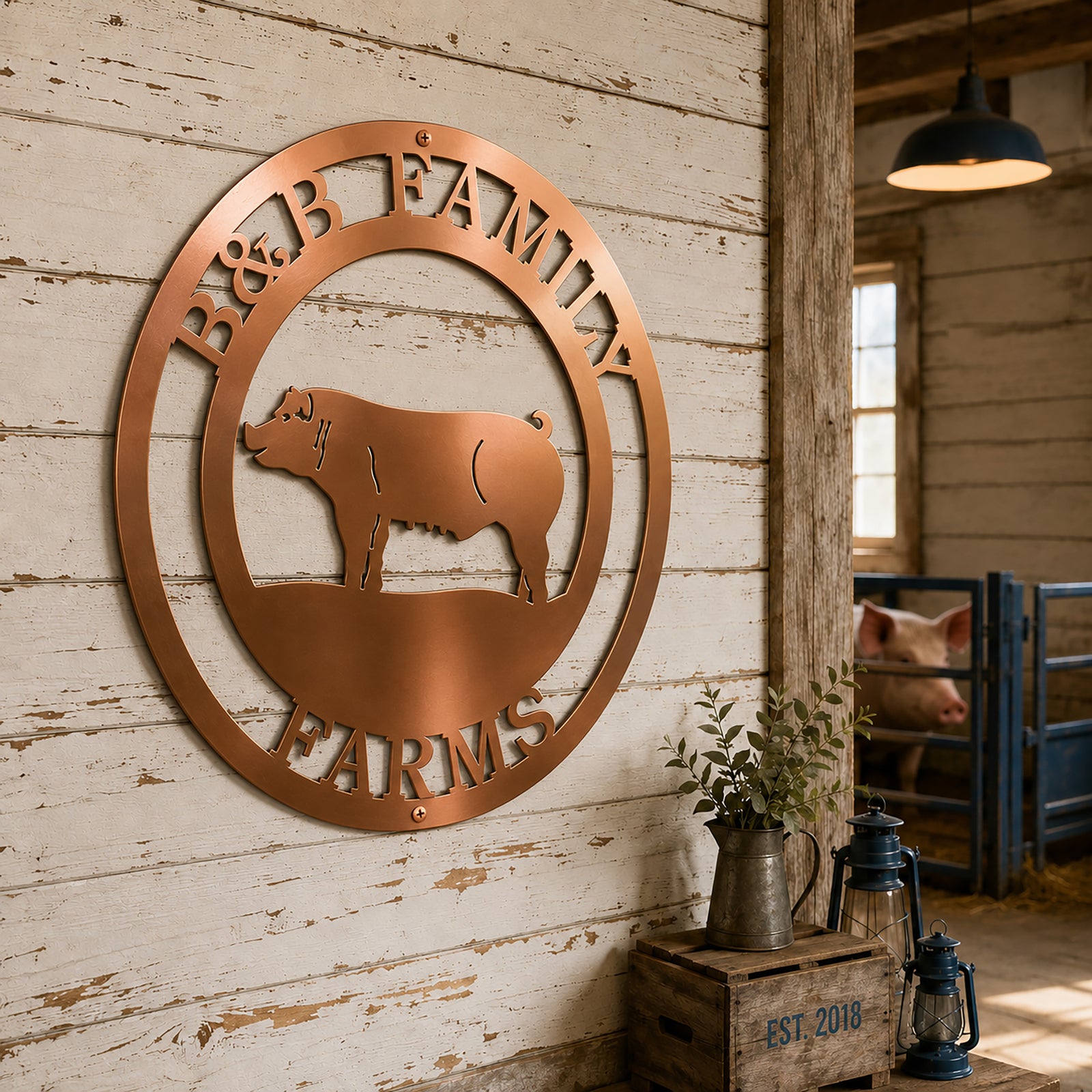 Elegant copper-coated round metal pig farm sign for B&B Family Farms hung on a white rustic shiplap wall inside a stable with a real pig visible in the background.