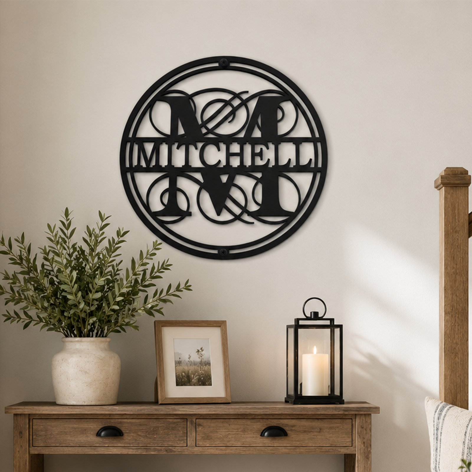 Black personalized metal family name sign with elegant monogram lettering mounted above a rustic entryway console table
