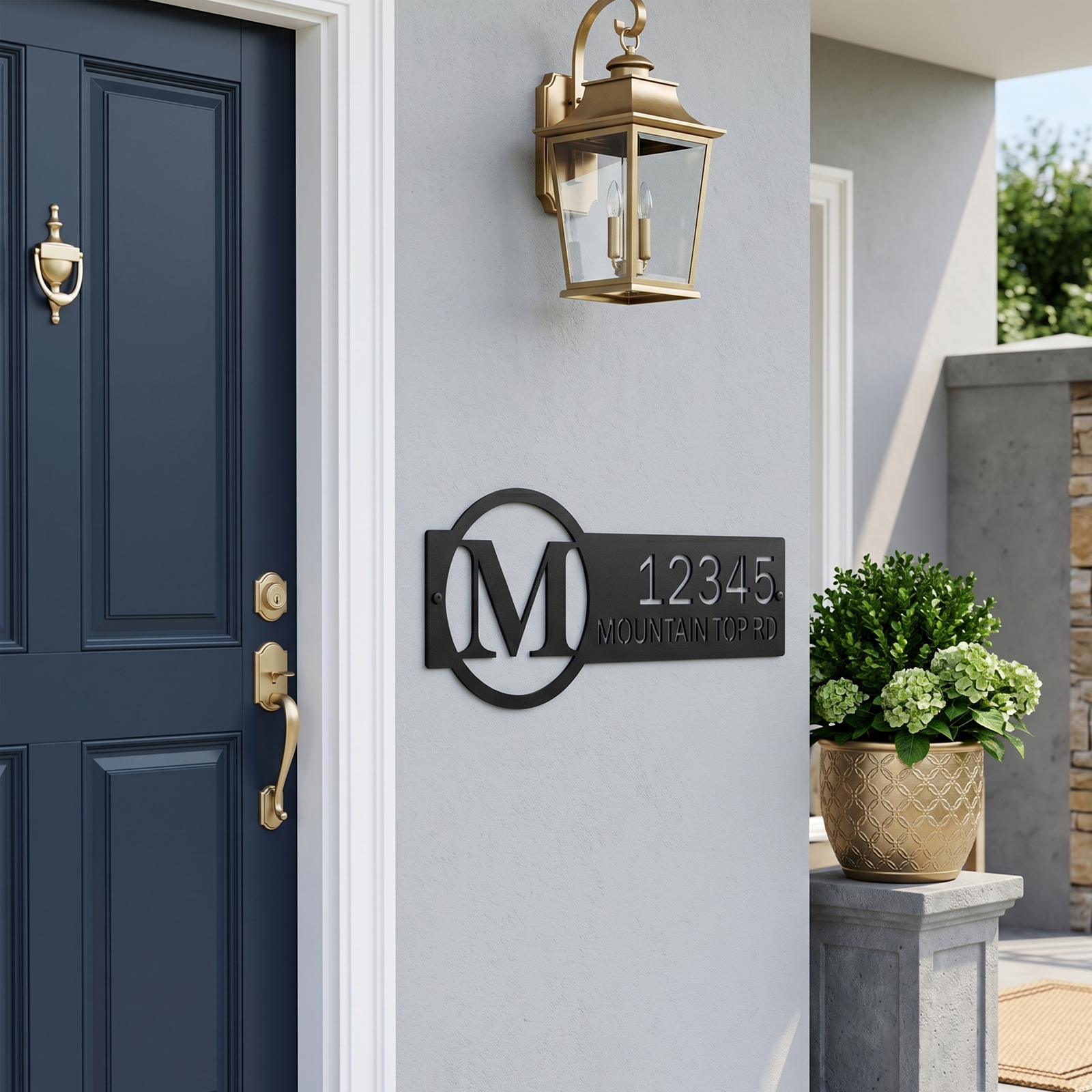 Black custom monogram house number sign displayed near front door with wall lantern
