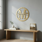 Custom Antique Gold metal monogram sign featuring the letter M, family name Matthews, and established year mounted above a modern console table.