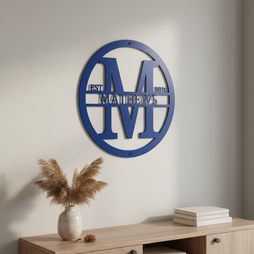 Custom Royal Blue metal monogram sign featuring the letter M, family name Matthews, and established year displayed on a neutral interior wall.
