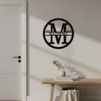 Custom Satin Black metal monogram sign featuring the letter M, family name Matthews, and established year displayed on an elegant interior wall.