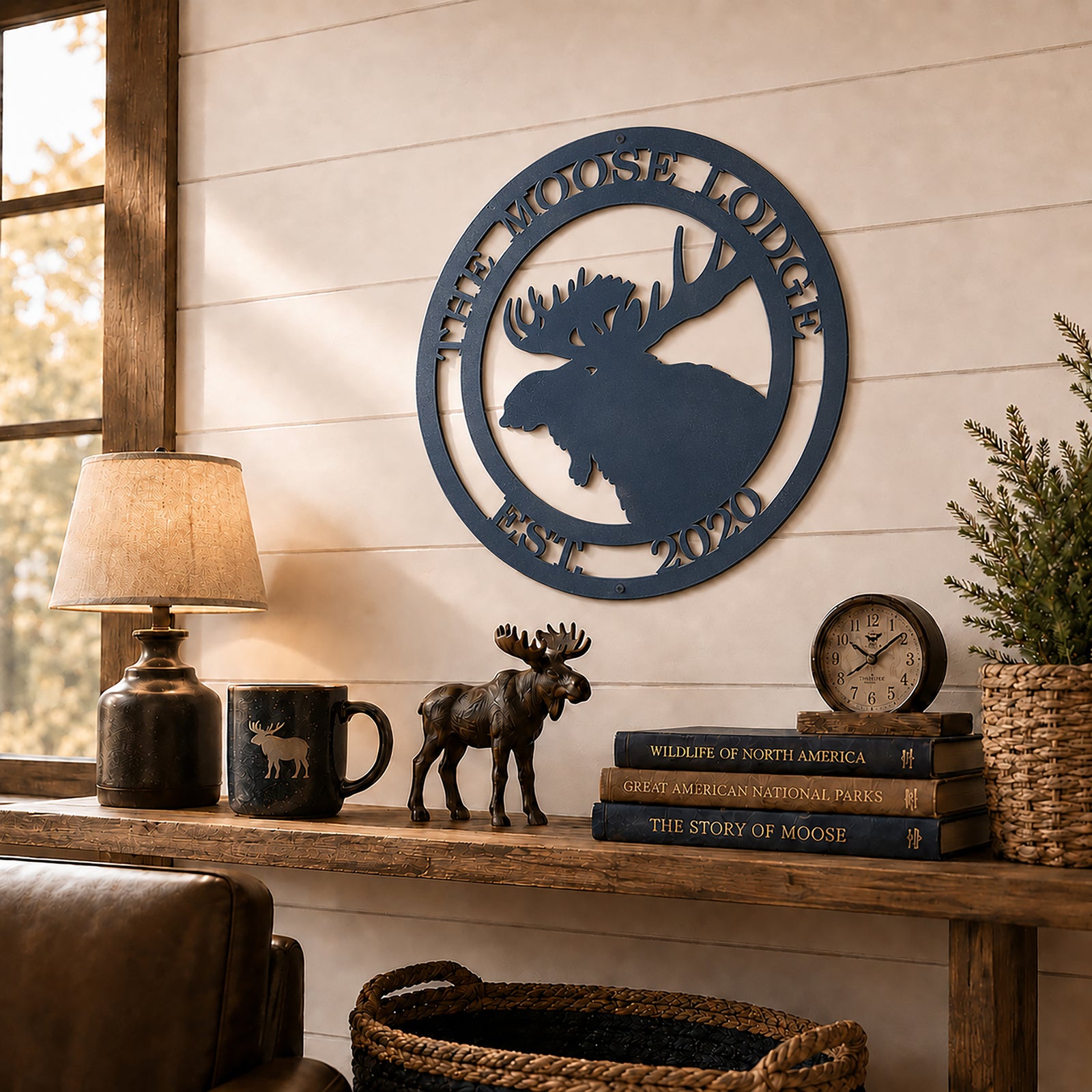 Navy blue custom moose lodge metal sign mounted above rustic shelf with lodge décor books and wildlife accents