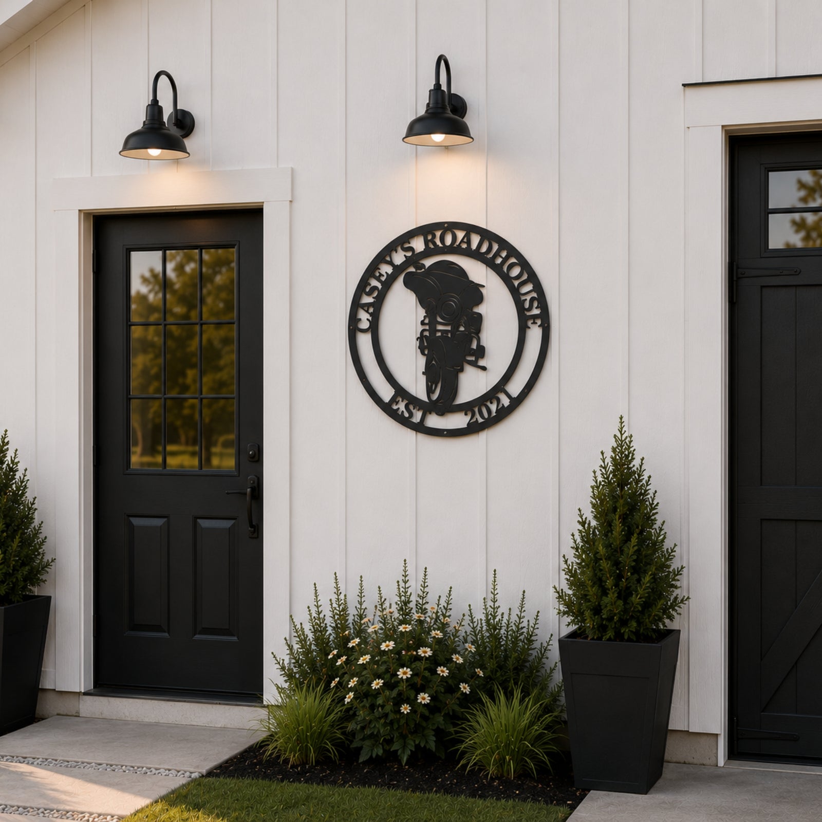 Personalized motorcycle metal wall sign with custom roadhouse name mounted on modern farmhouse exterior wall