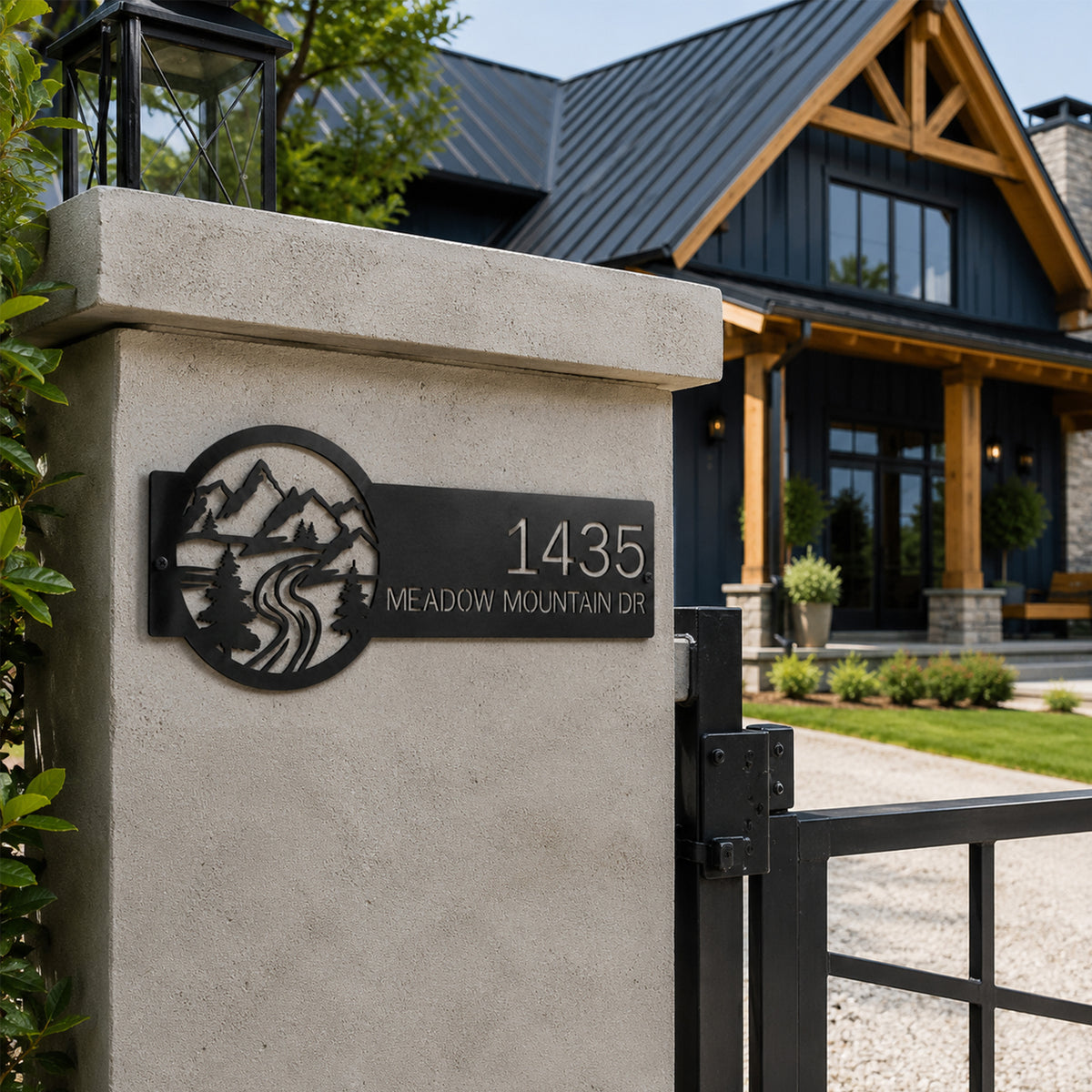 Black custom mountain address metal sign mounted on stone entry pillar featuring mountain landscape pine trees and personalized house number modern farmhouse decor