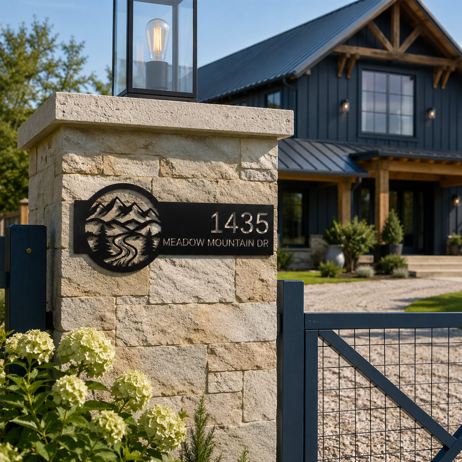 Personalized metal mountain address sign attached to stone gate pillar featuring pine trees river design and custom house number outdoor driveway decor
