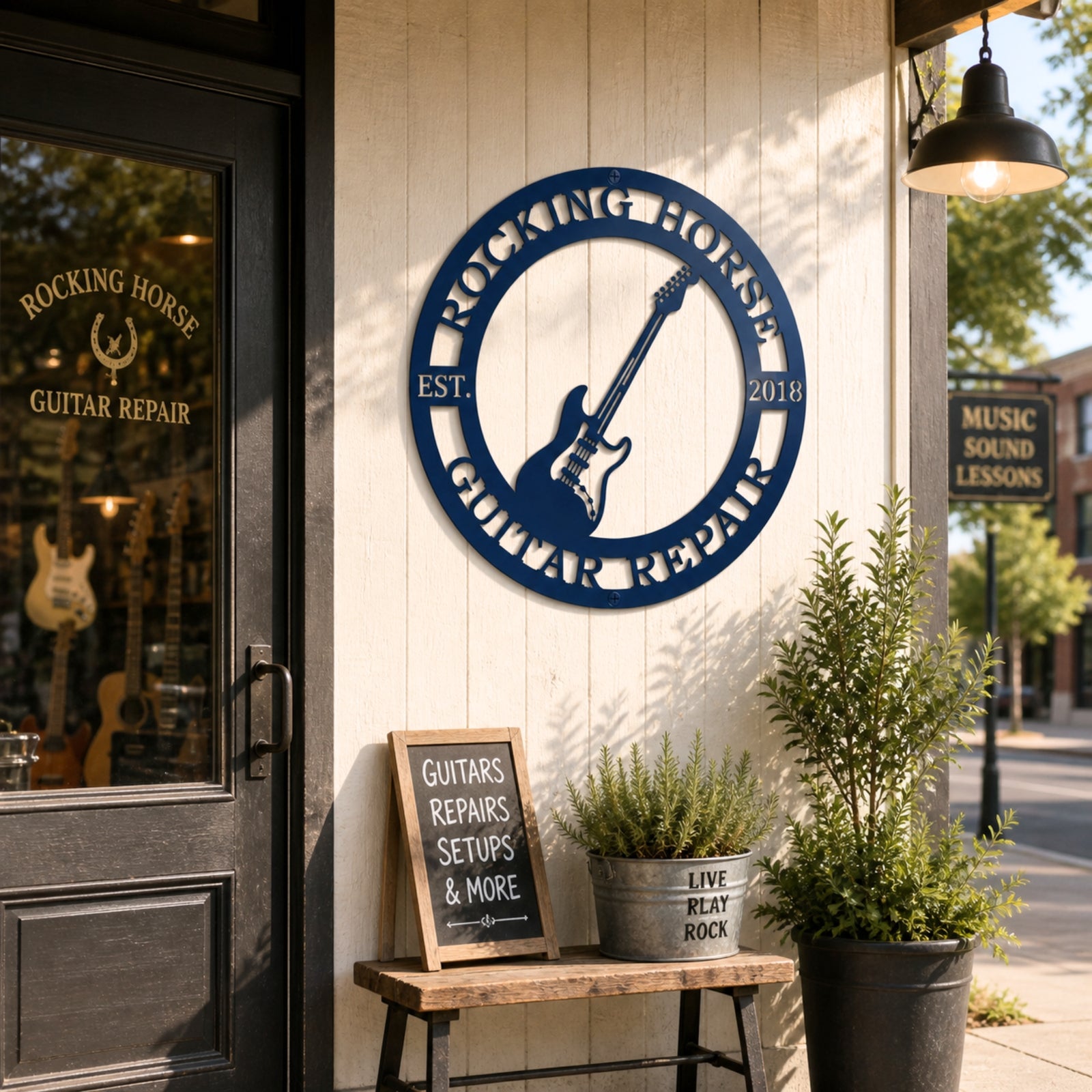 Blue custom guitar repair metal sign displayed outside storefront with rustic bench plants and music shop entrance décor