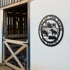 Black pig resort metal sign with farm animal silhouettes mounted outside a rustic barn entrance