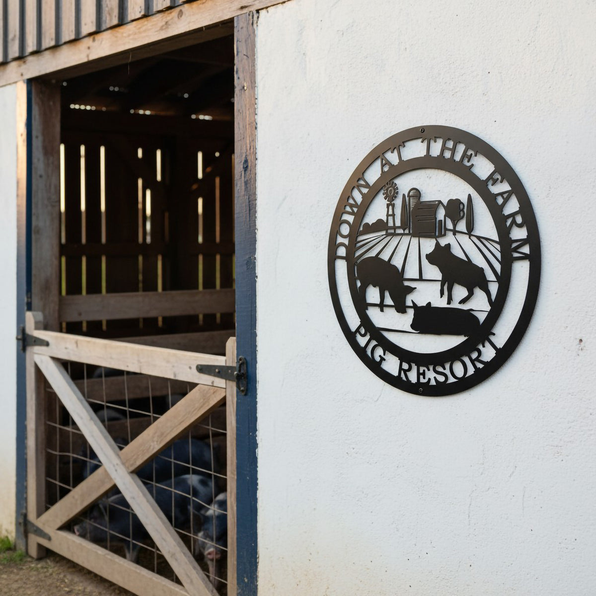 Black pig resort metal sign with farm animal silhouettes mounted outside a rustic barn entrance