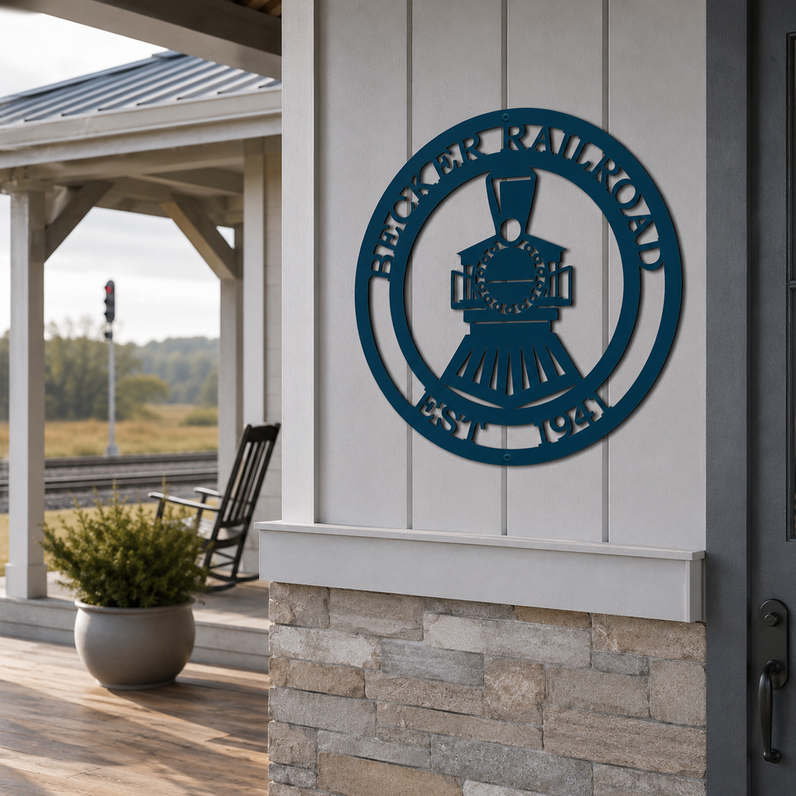 Teal Becker Railroad metal train wall art mounted on modern farmhouse porch near railway tracks