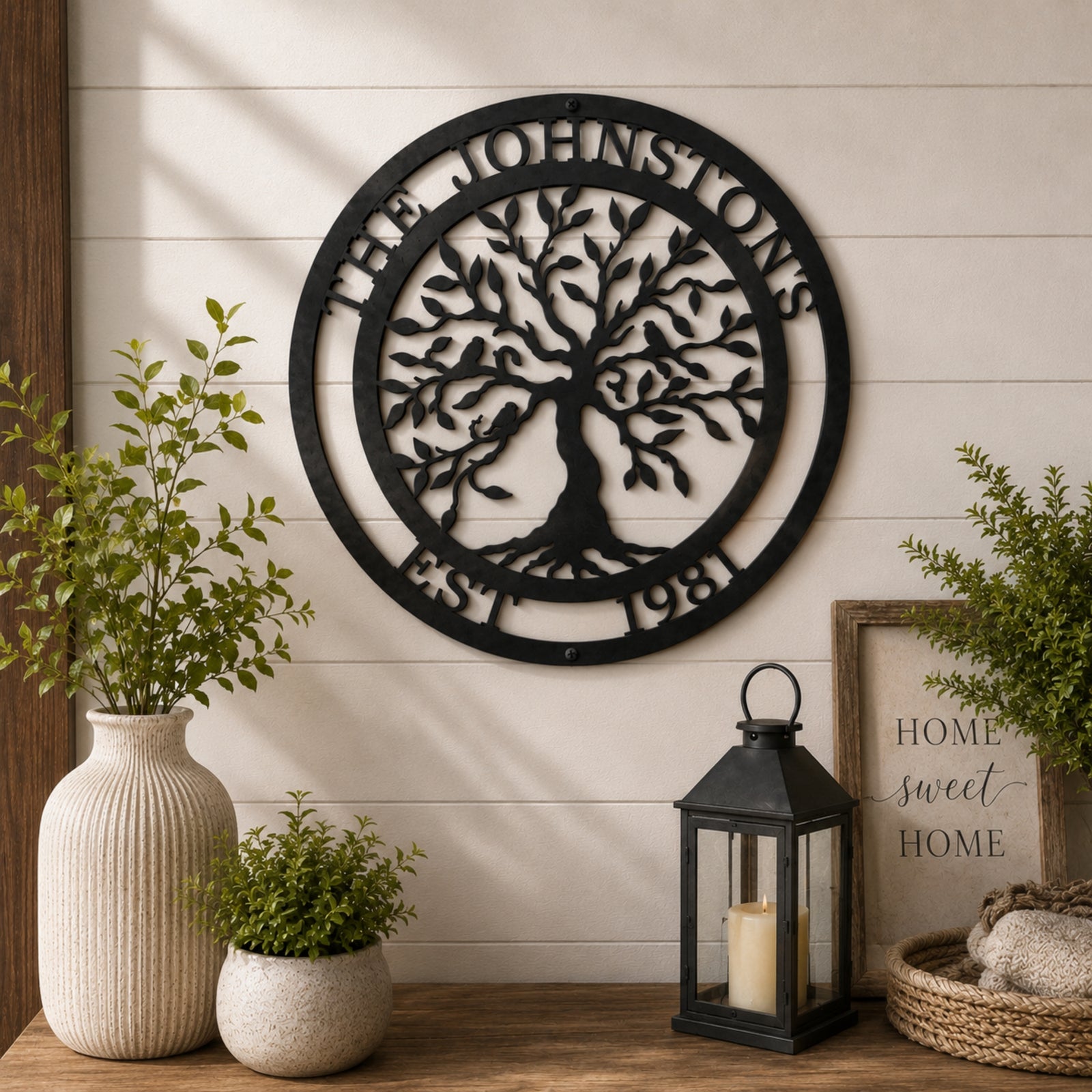 Personalized anchor monogram metal sign hanging above a rustic console table with lantern and farmhouse home décor accents