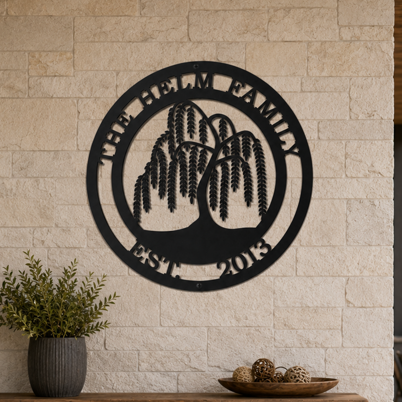 Custom weeping willow tree metal sign — personalized outdoor family name sign in black powder-coated steel mounted on a natural stone exterior wall.