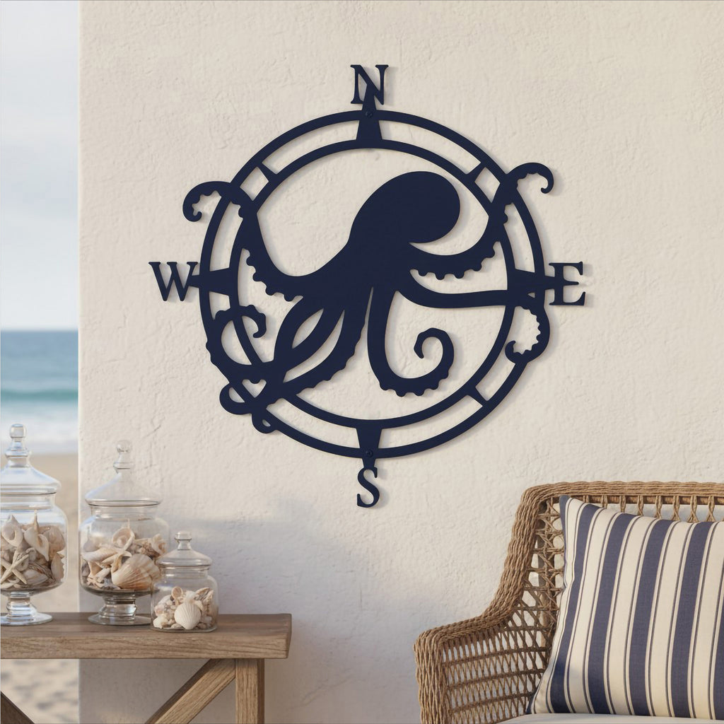 Deep navy blue finish of the custom octopus compass metal wall art displayed on an outdoor wall next to a wicker chair with a striped cushion.