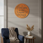 Vibrant medium blue custom metal cutout sign with starry details styled on a living room wall above a wooden table with a hot coffee mug.