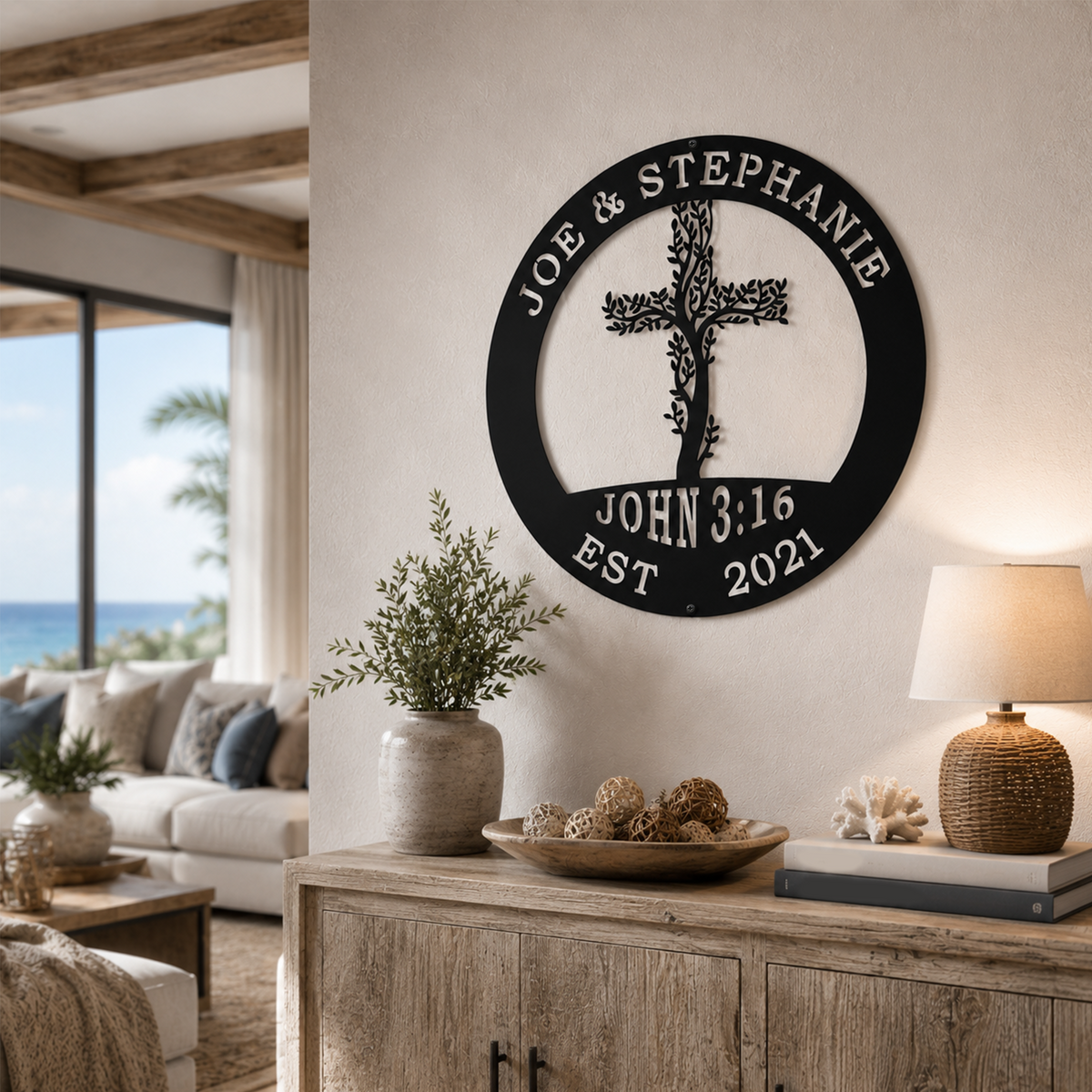 Black personalized metal cross and scripture sign displayed on a white living room wall above a rustic wooden console cabinet.