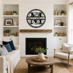Black circular monogram family name sign with Mitchell lettering displayed above a living room fireplace in a bright modern home