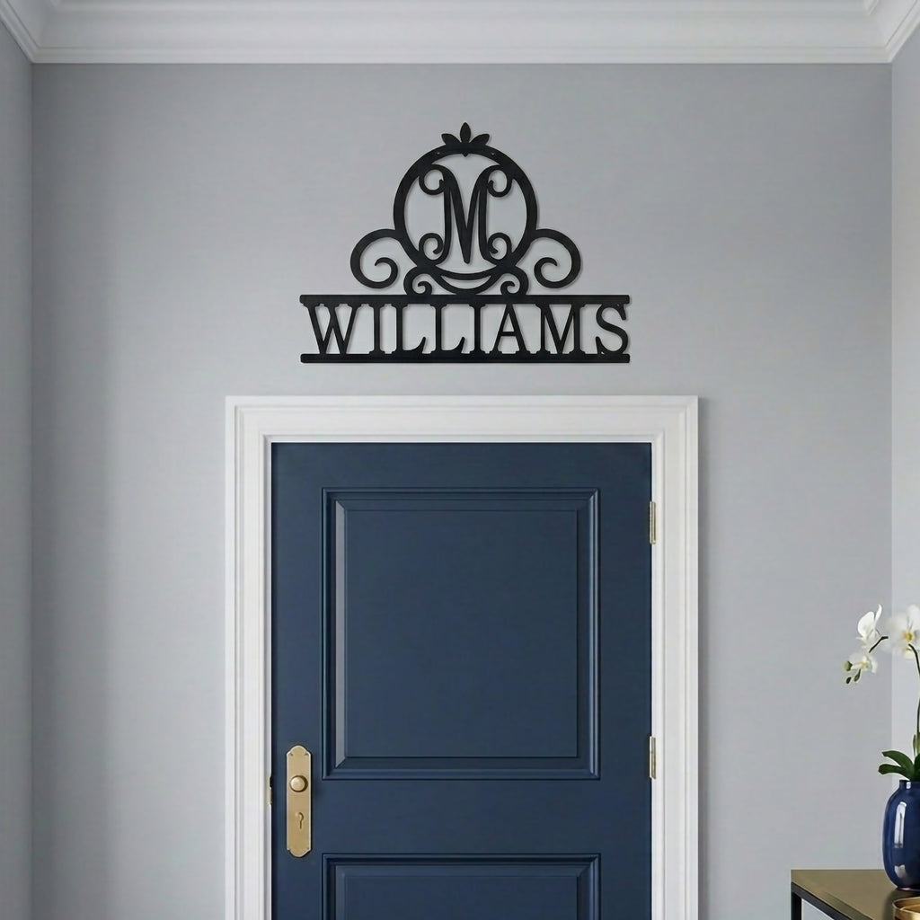 Black Williams monogram metal wall sign mounted above a navy blue interior door with minimalist modern home decor