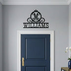 Black Williams monogram metal wall sign mounted above a navy blue interior door with minimalist modern home decor
