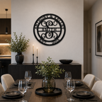 A deep onyx black circular metal sign customized with "ANTHONY & KELLEY SMITH EST. 2015" is mounted on a central dining room divider wall. Below the sign, a dark fluted sideboard is decorated with candles and greenery, positioned behind a fully set modern dark wood dining table with wine glasses and black plates.