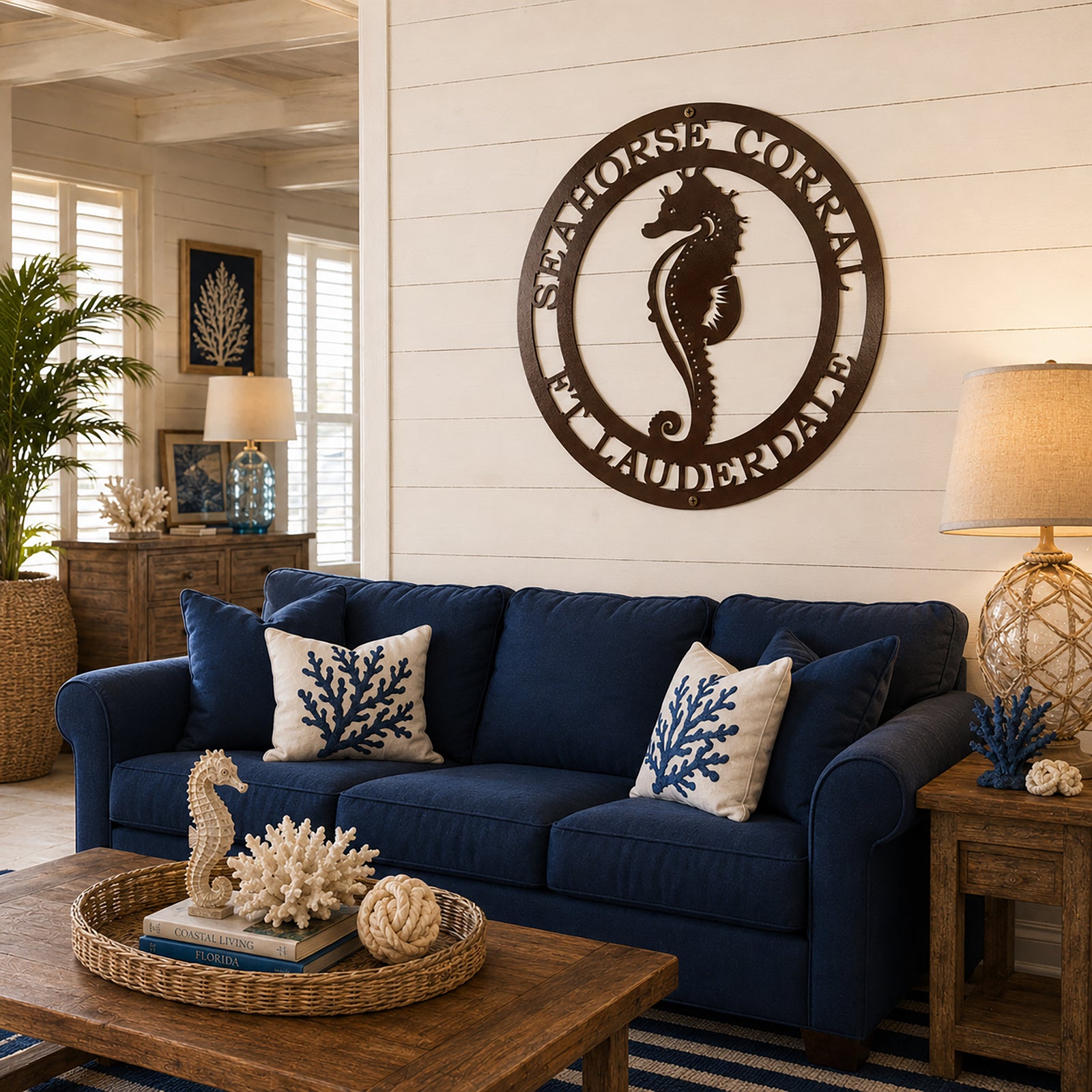 Espresso brown seahorse personalized metal sign displayed above blue coastal living room sofa
