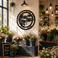 Custom Koi Fish and Lotus Flower Metal Wall Decor Sign in Black hanging on an interior wall above a dark gray wooden bench with potted flowers