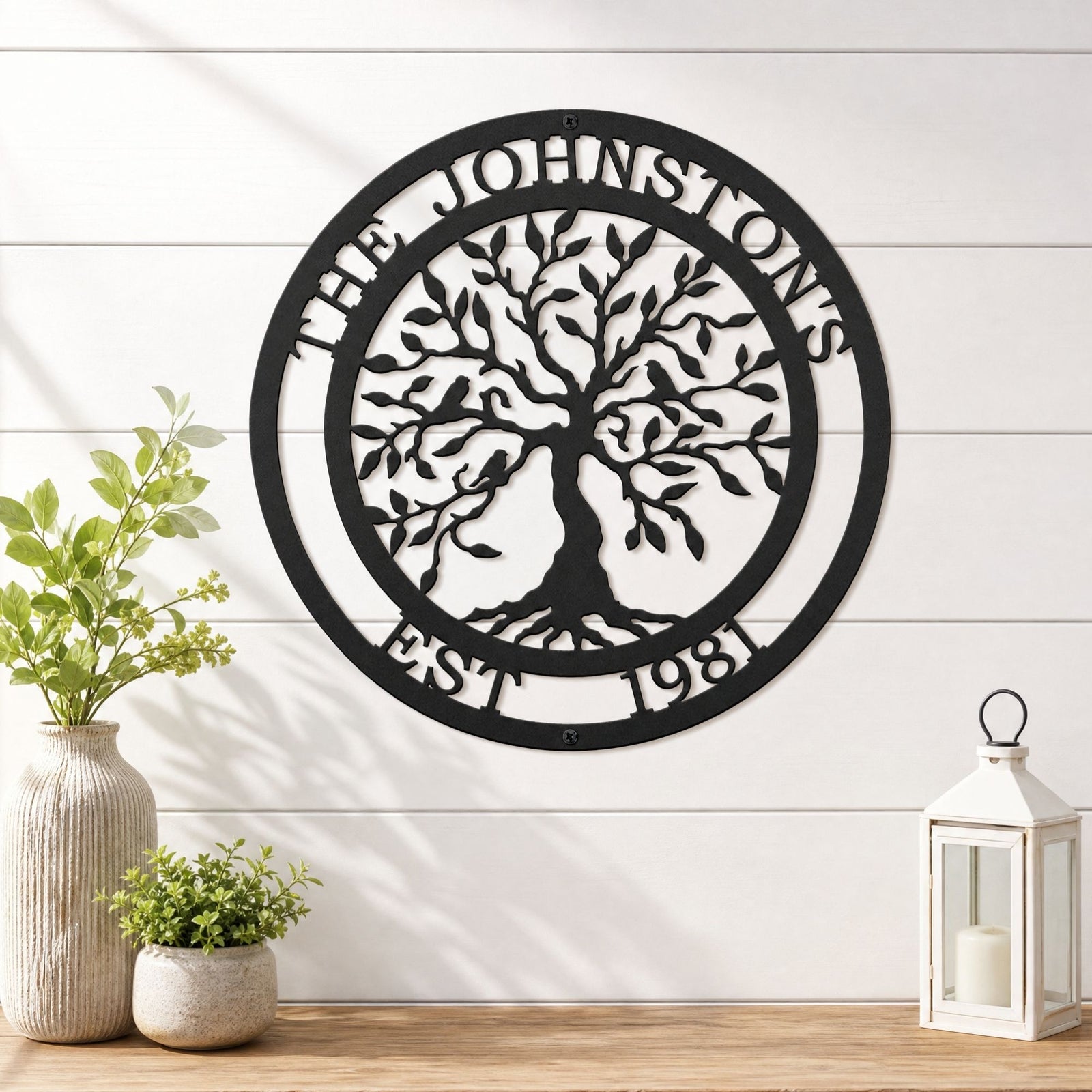 Personalized family tree metal wall art with birds and established date styled on white shiplap wall with lantern decor